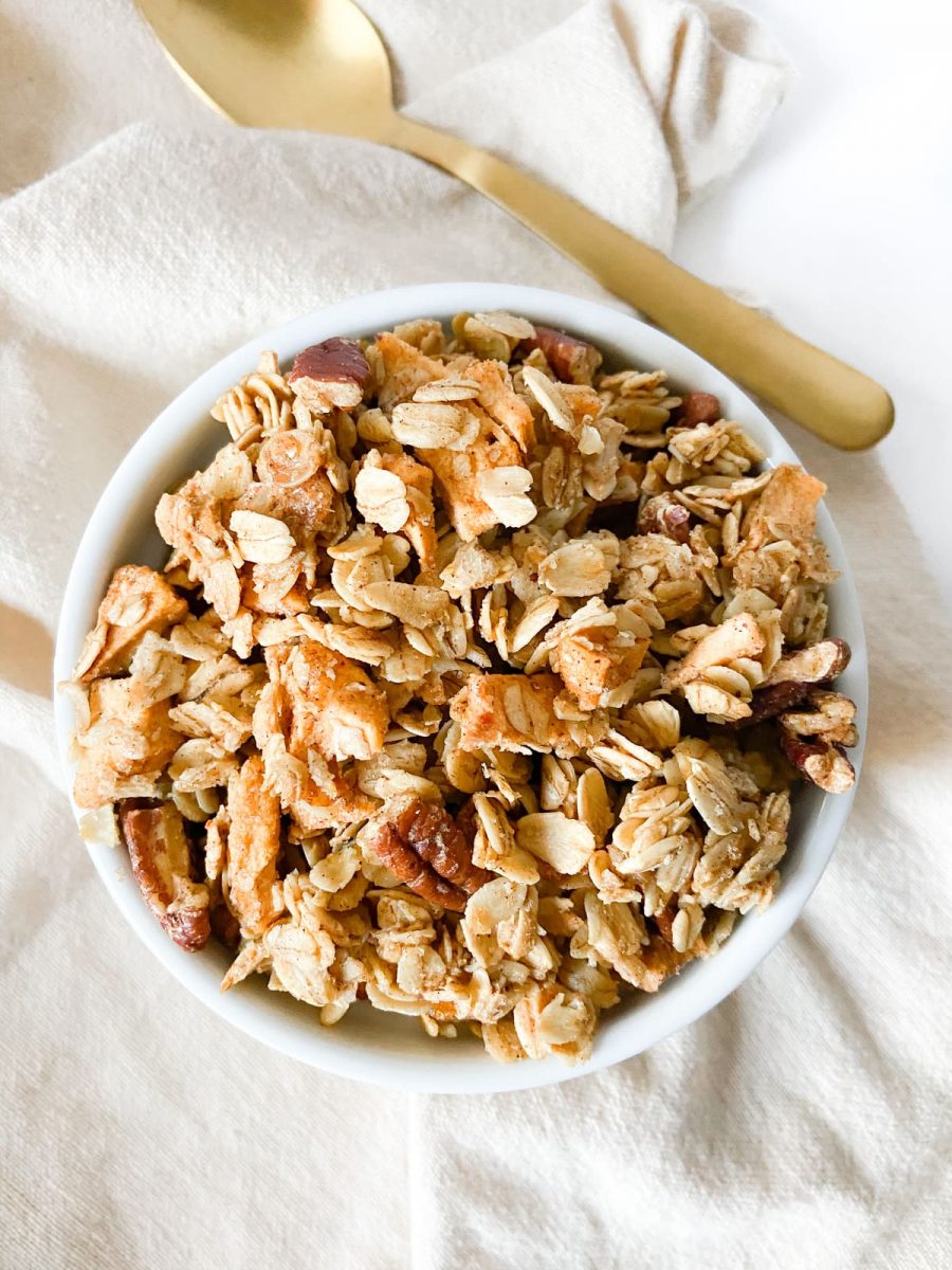 Spiced apple granola in a bowl with a spoon.
