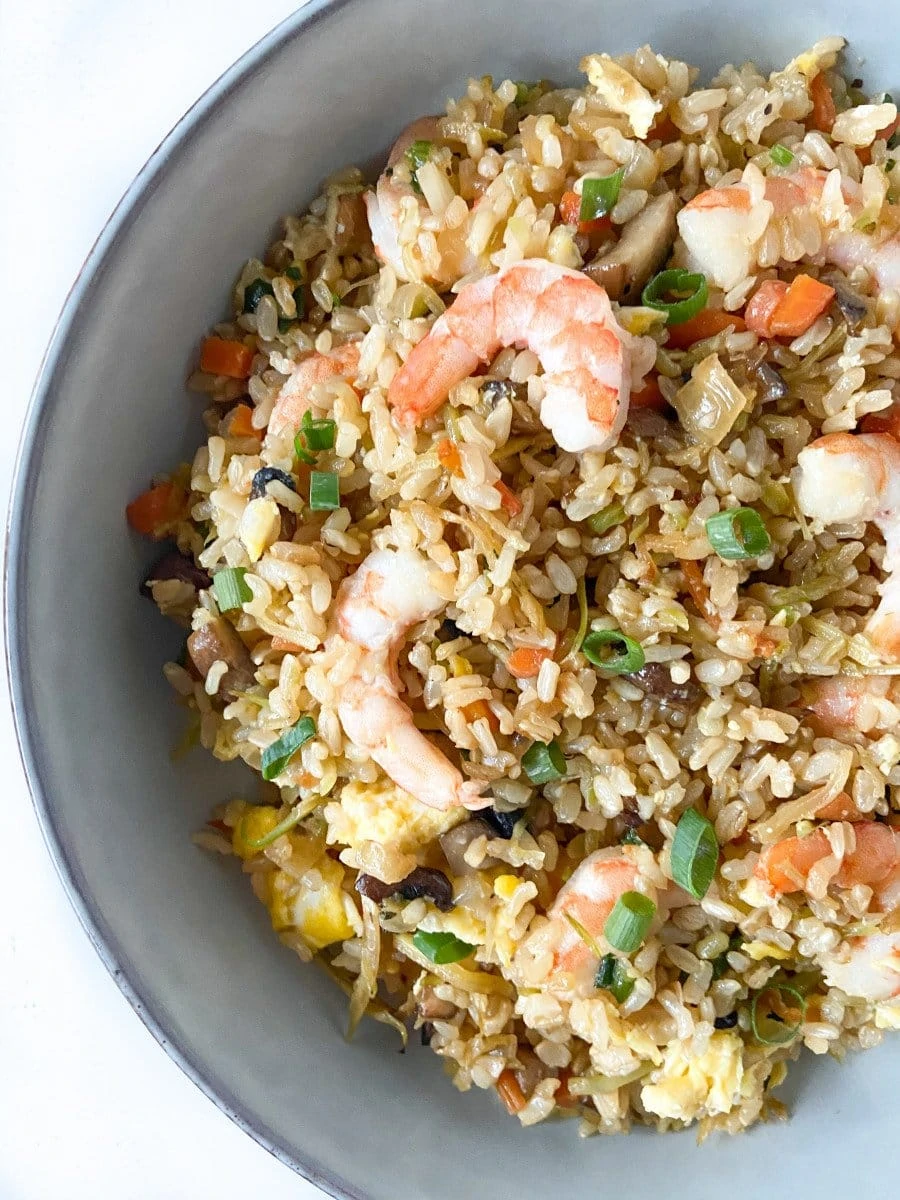 A bowl of fried rice with shrimp.
