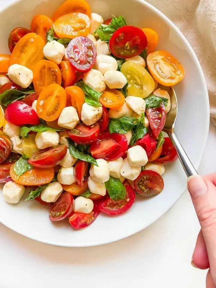 A bowl full of Caprese salad cherry tomatoes