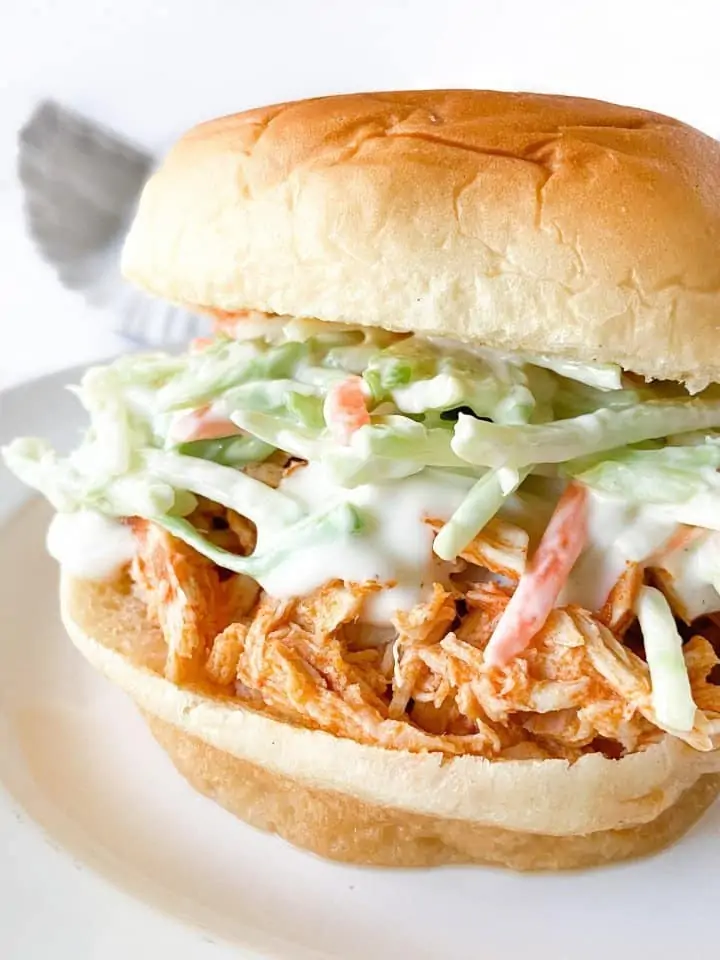 Slow-Cooker Buffalo Chicken on a bun with coleslaw