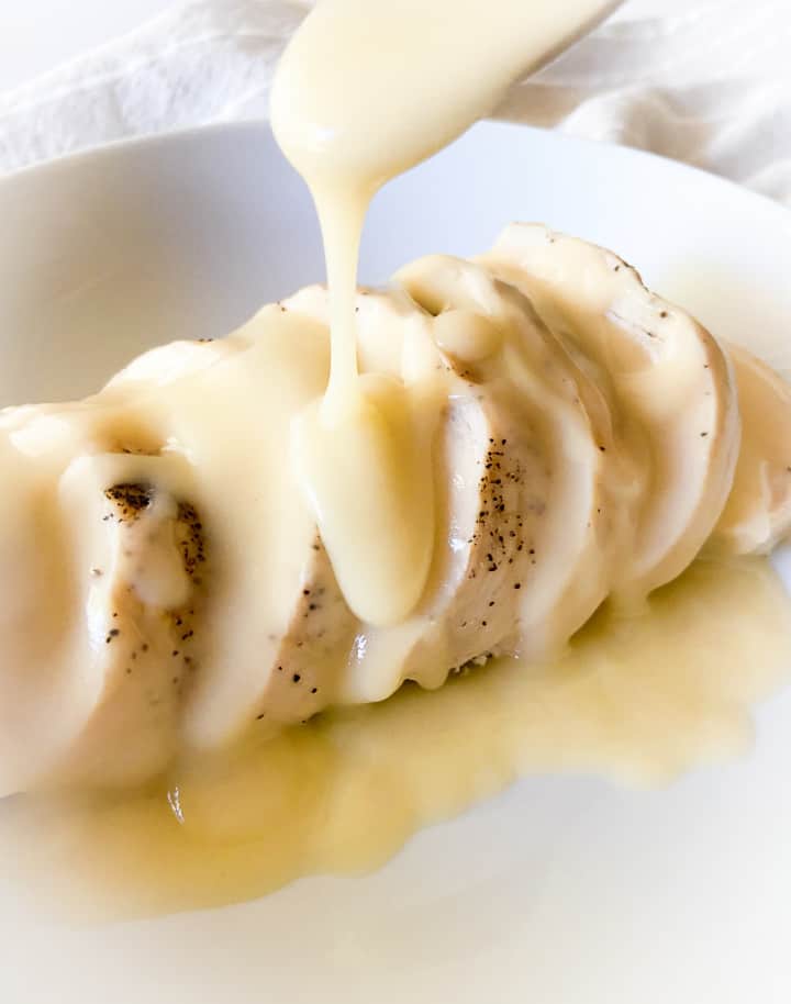 Veloute sauce poured over sliced chicken. 