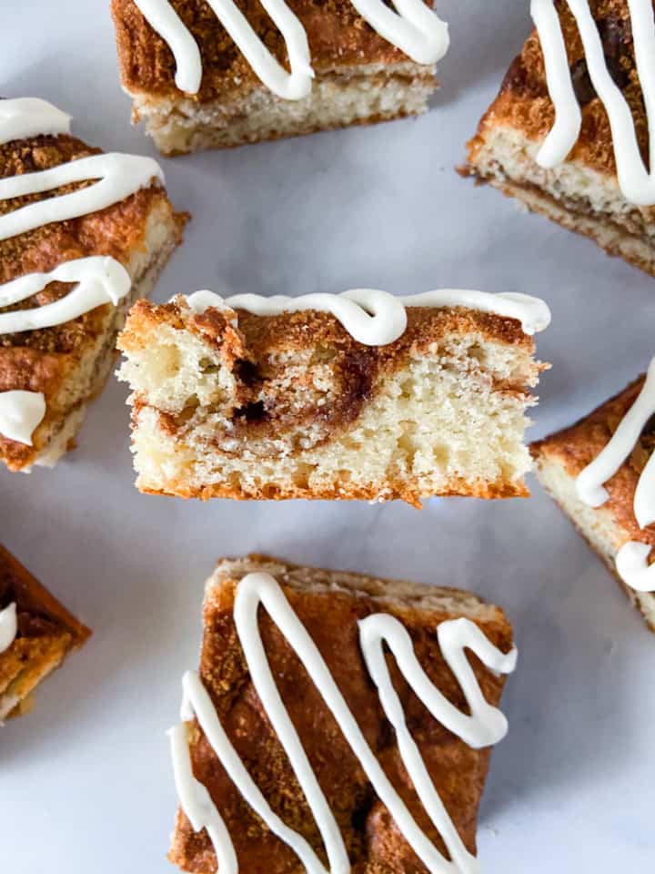 A close-up of one coffee cake slice with others around it.