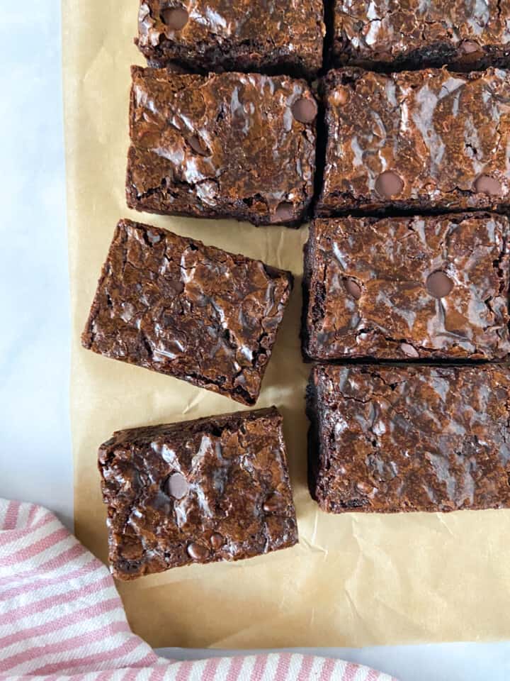 A selection of sliced brownies on parchment paper.