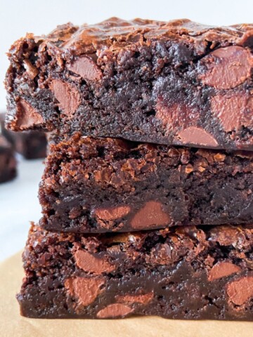 A stack of three fudgy brownies.