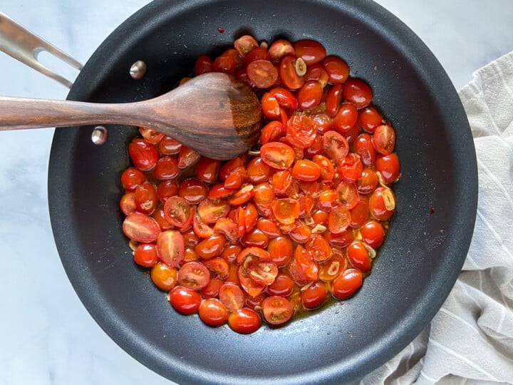 A large skillet with cherry tomato sauce.
