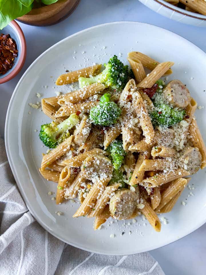 A plate of chicken sausage and broccoli pasta.