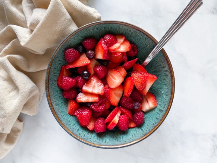 Macerated berries in a blue bowl.