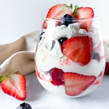 A completed and garnished Eton mess serving in a glass.