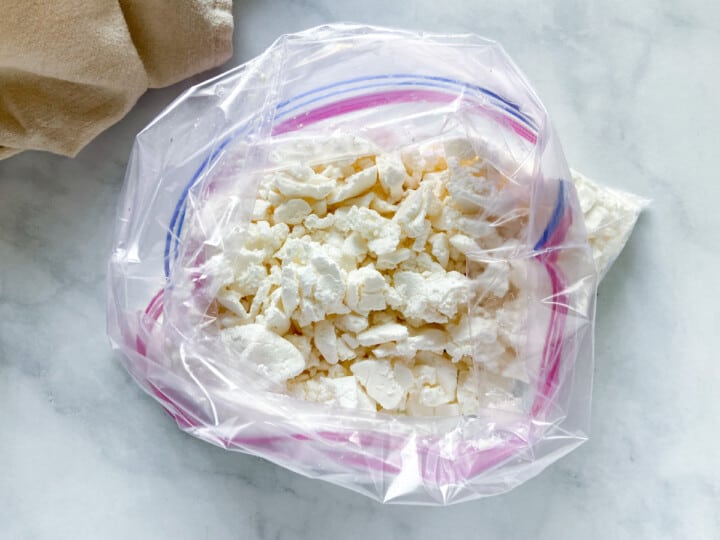 Crushed meringue cookies in a zip-top bag.