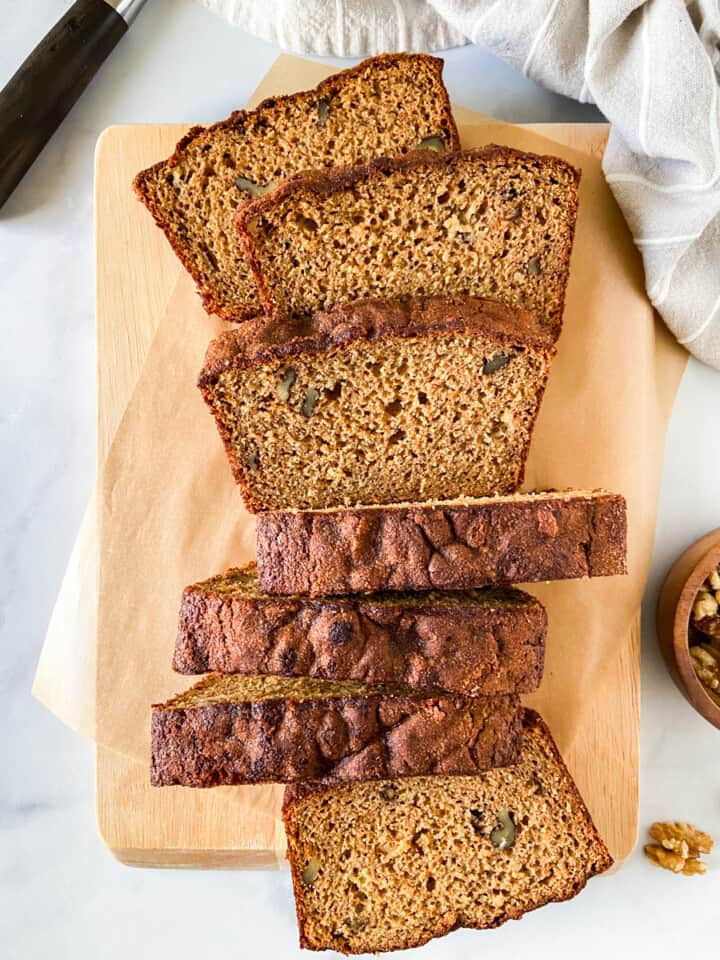 Protein banana bread slices on a parchment-lined cutting board.