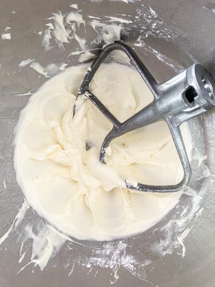 Cream cheese icing in a mixer bowl with the paddle attachment.