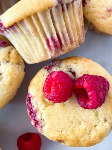White chocolate raspberry muffins with fresh raspberries.