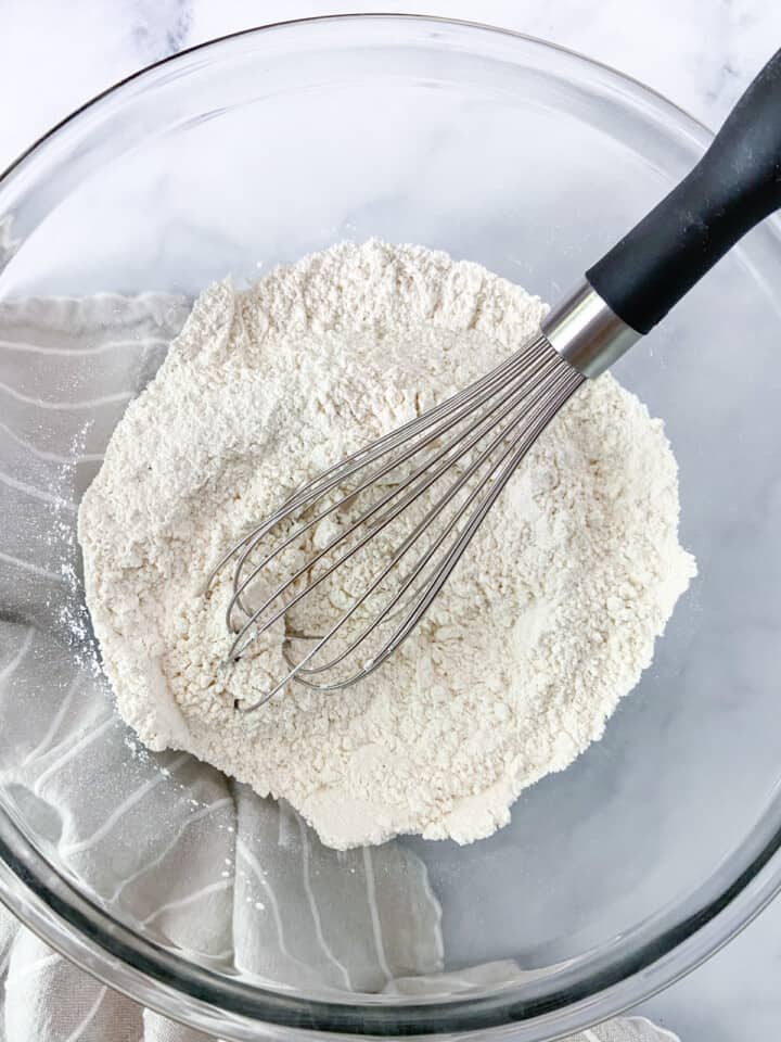 Dry ingredients in a large bowl with a whisk.