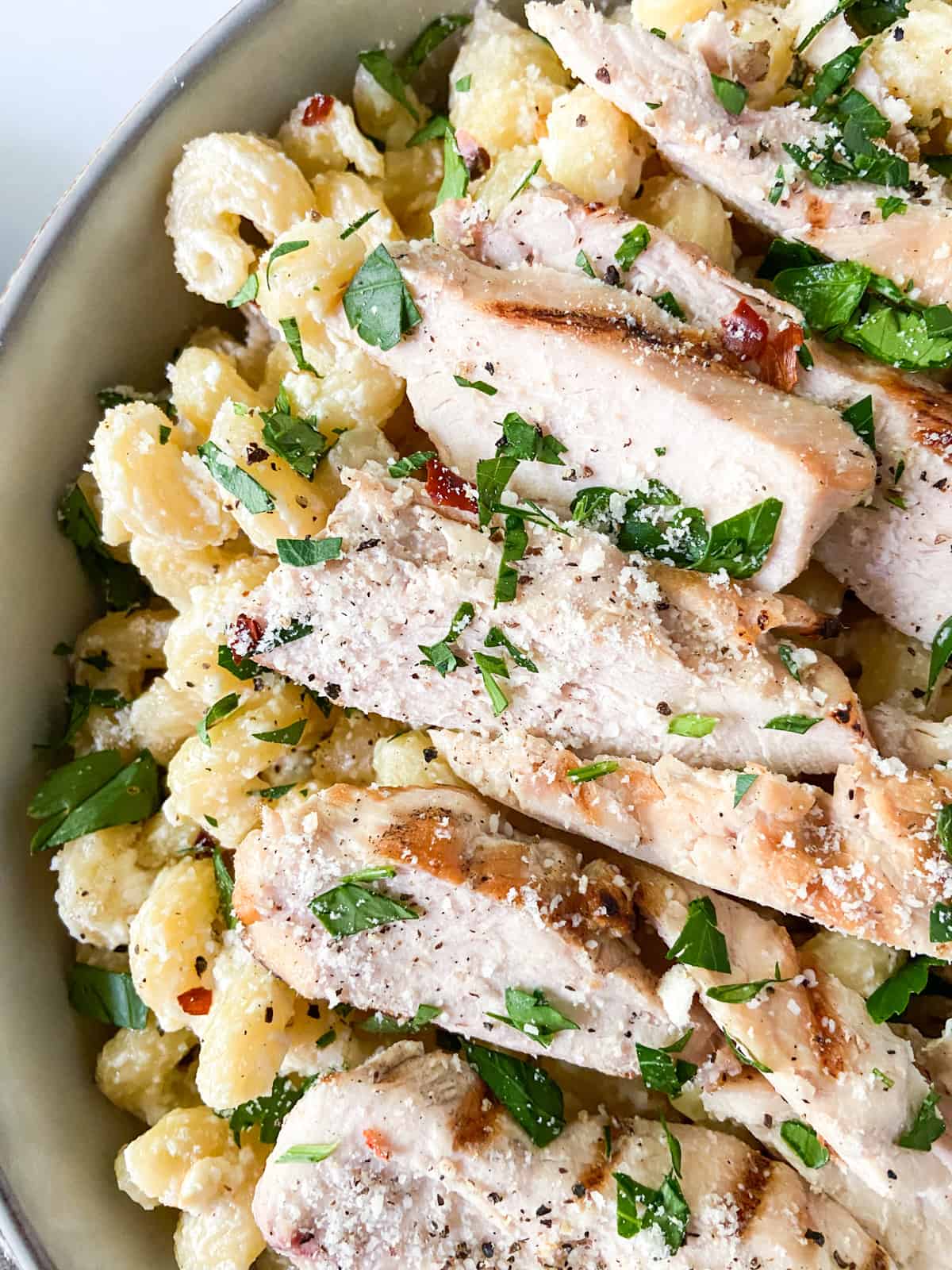 A bowl of feta pasta with chicken.