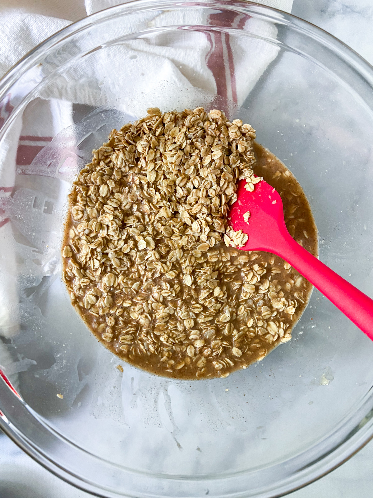Oatmeal mixture with liquid ingredients stirred in.