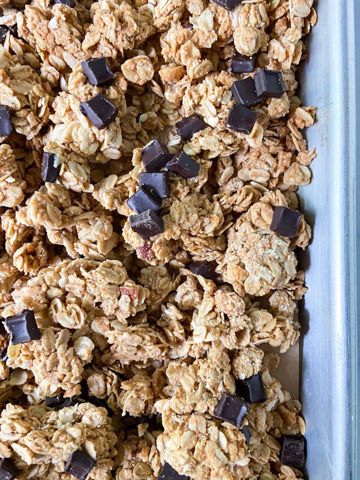 Peanut butter granola clusters on a parchment-lined tray.