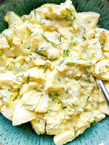 Egg salad with pickles in a bowl.