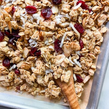 Toasted coconut granola on a parchment-lined tray.