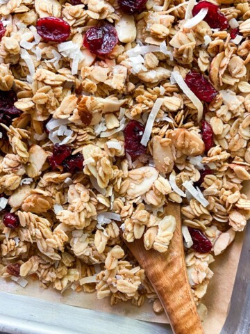 Toasted coconut granola on a parchment-lined tray.