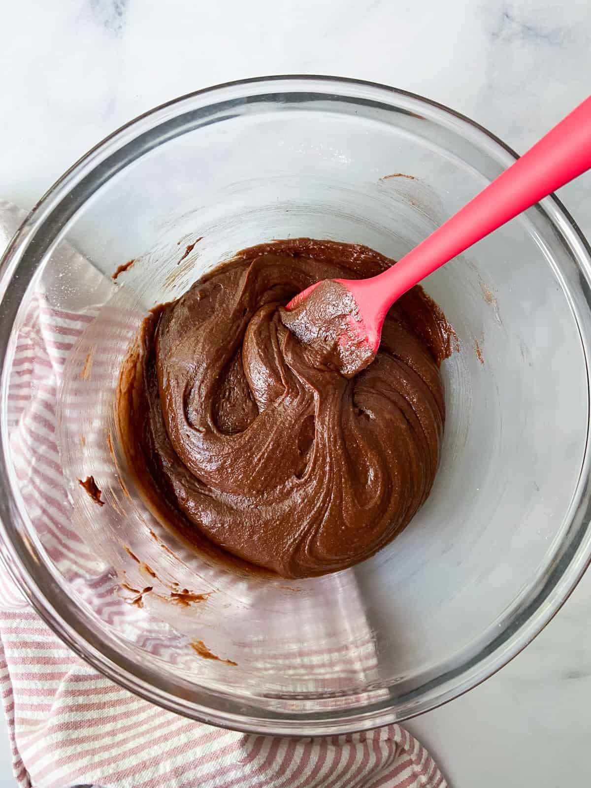 Brownie batter in a bowl with a spatula.