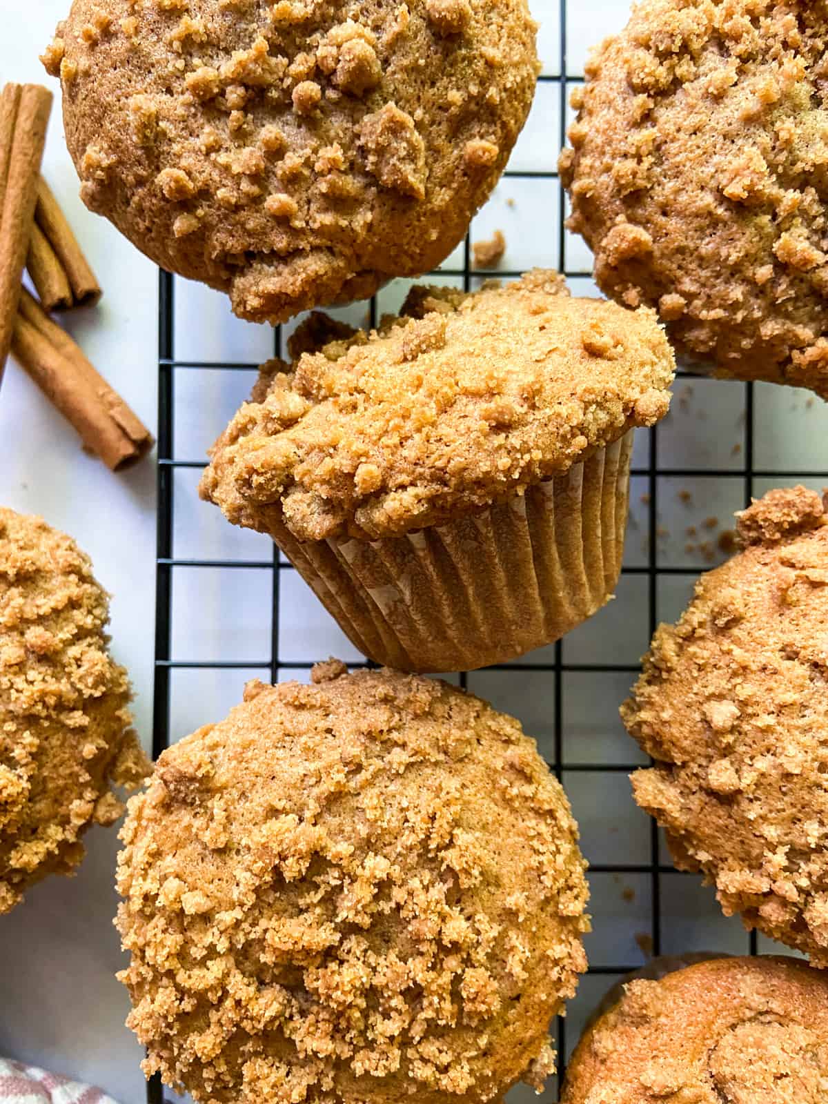 Cinnamon streusel muffins on a cooling rack.