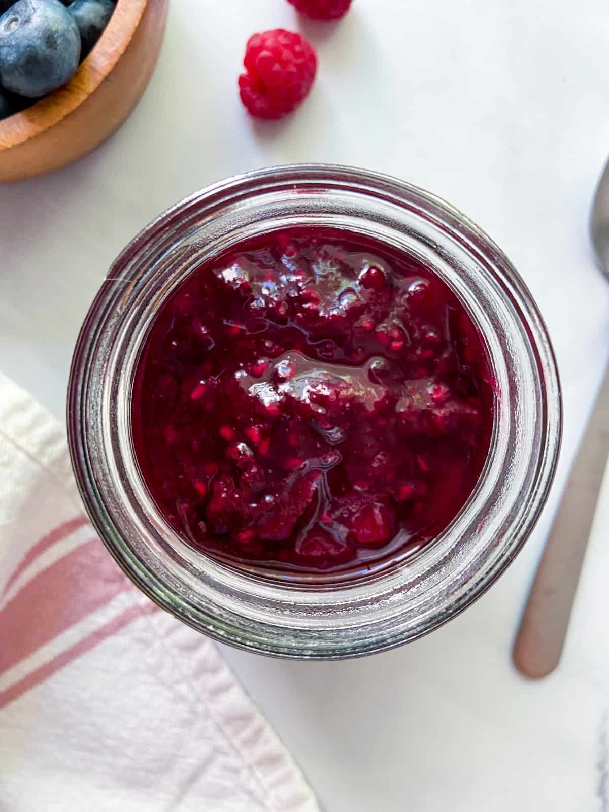Mixed berry compote in a jar.