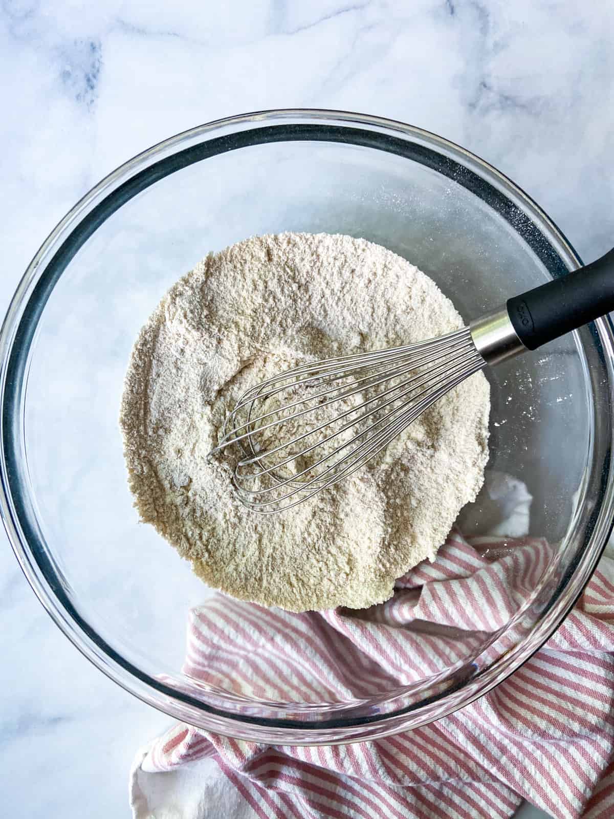 The dry ingredients in a large bowl with a whisk.