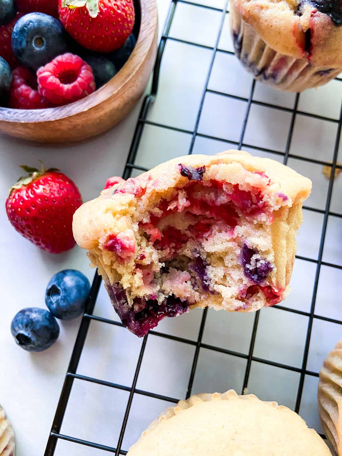 A muffin with a bite taken out of it.