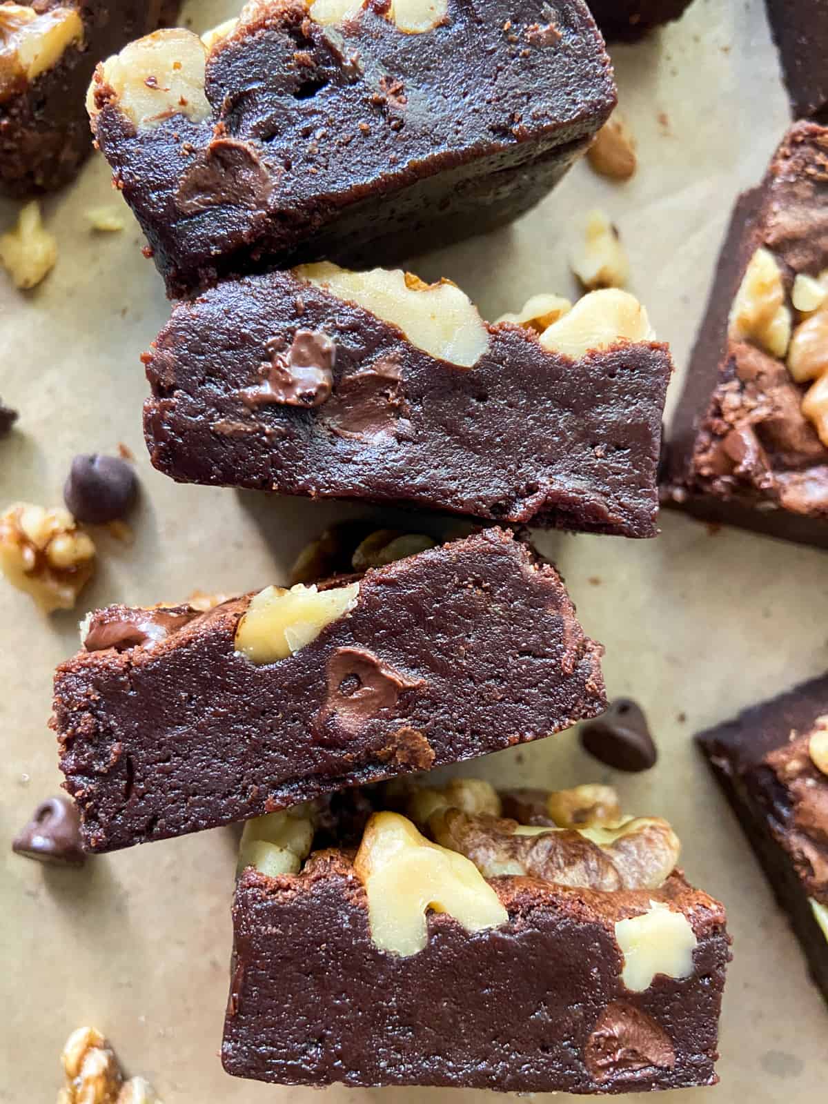 A close-up of fudgy double chocolate brownies with walnuts and chocolate chips.