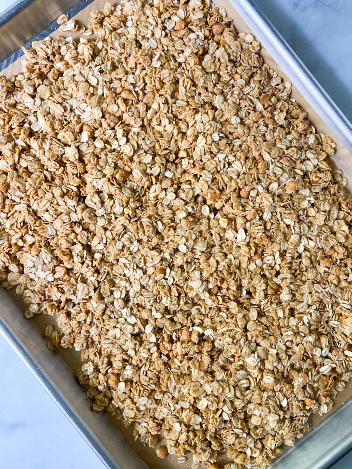 A tray of unbaked peanut butter granola.