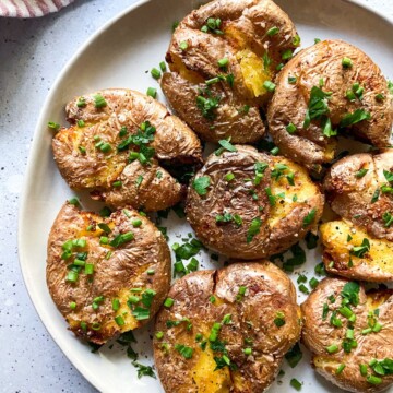 Air fryer smashed potatoes on a plate.