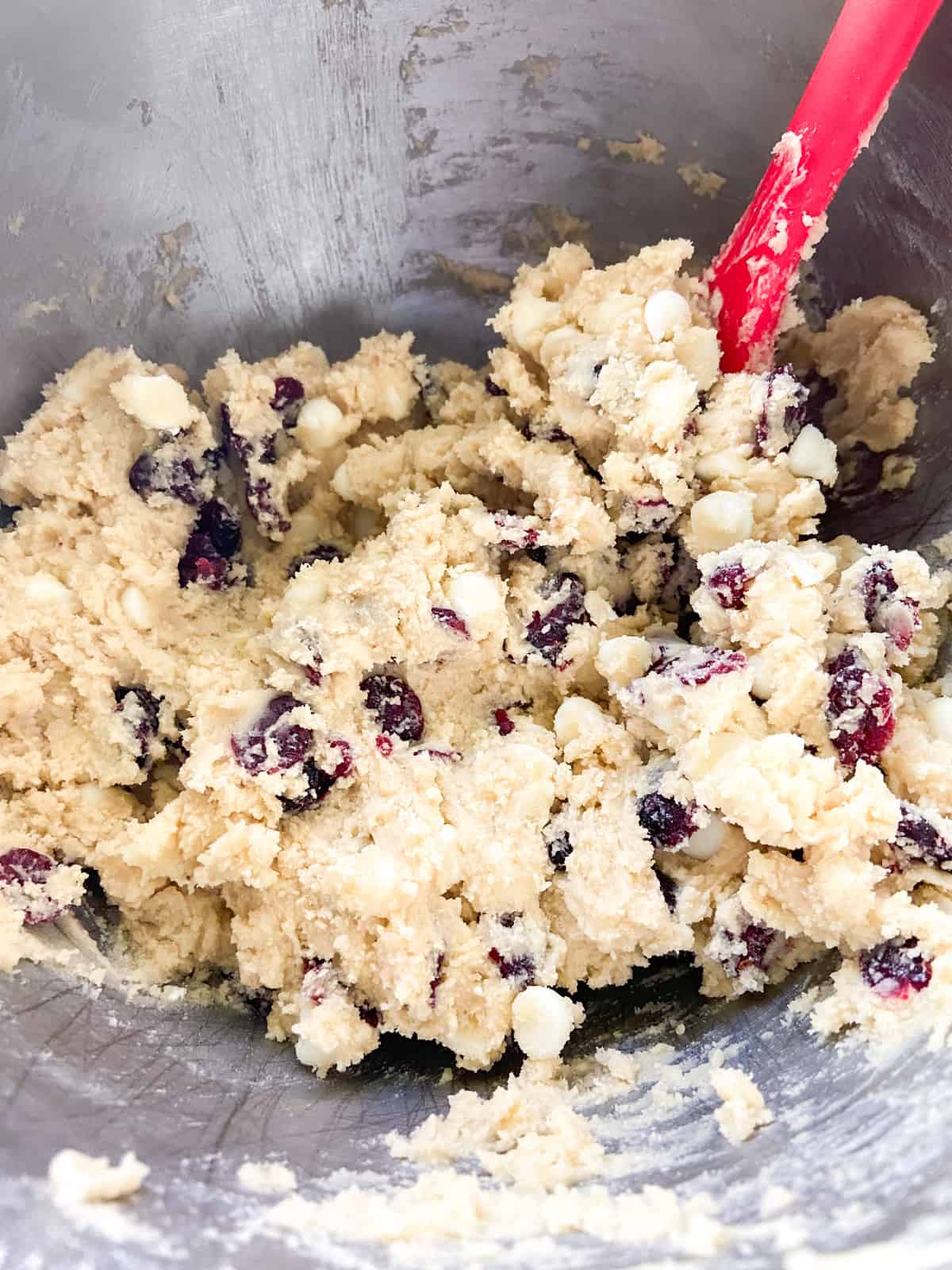 Cookie dough with cranberries and white chocolate chips mixed in.