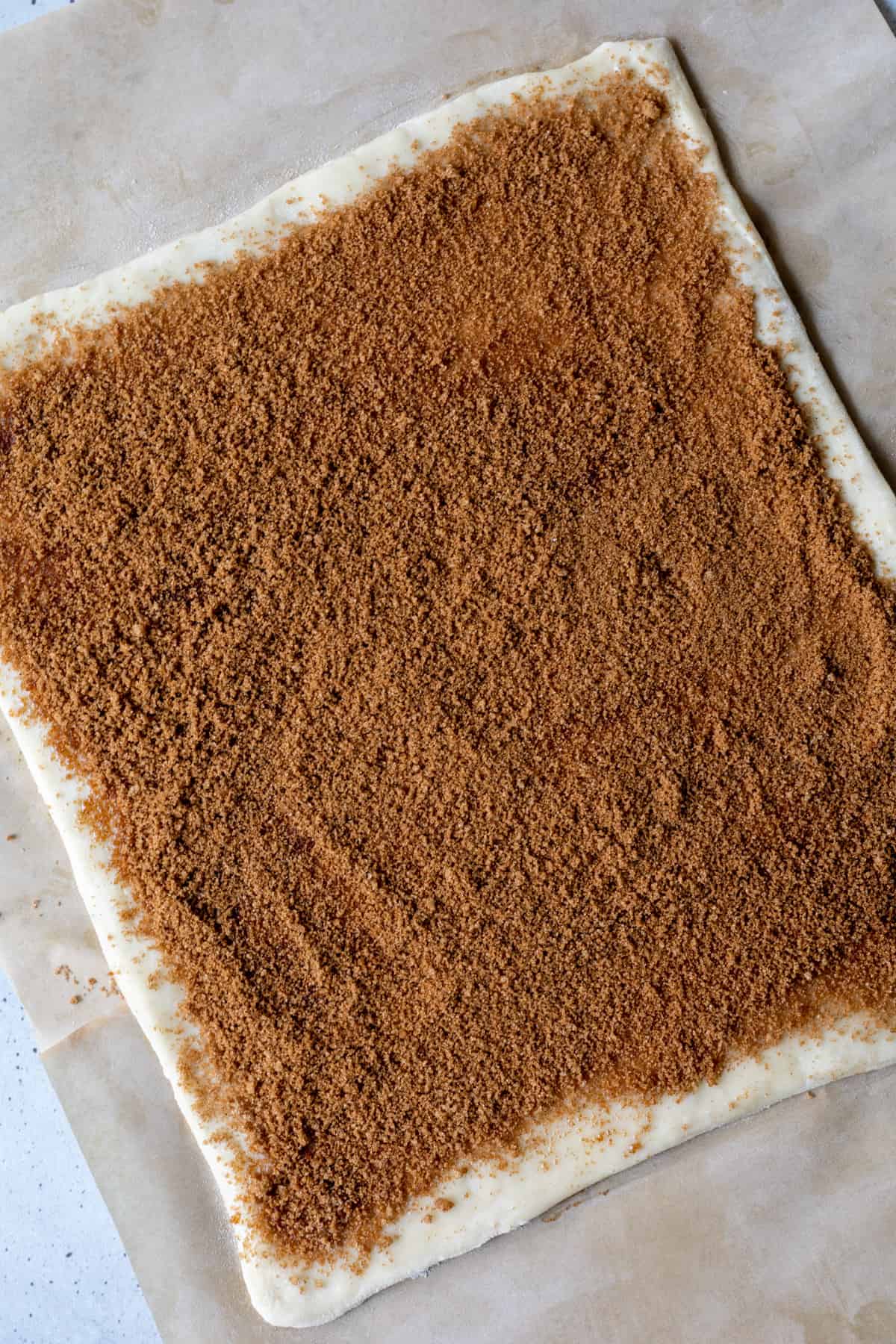 A puff pastry sheet coated in cinnamon sugar.