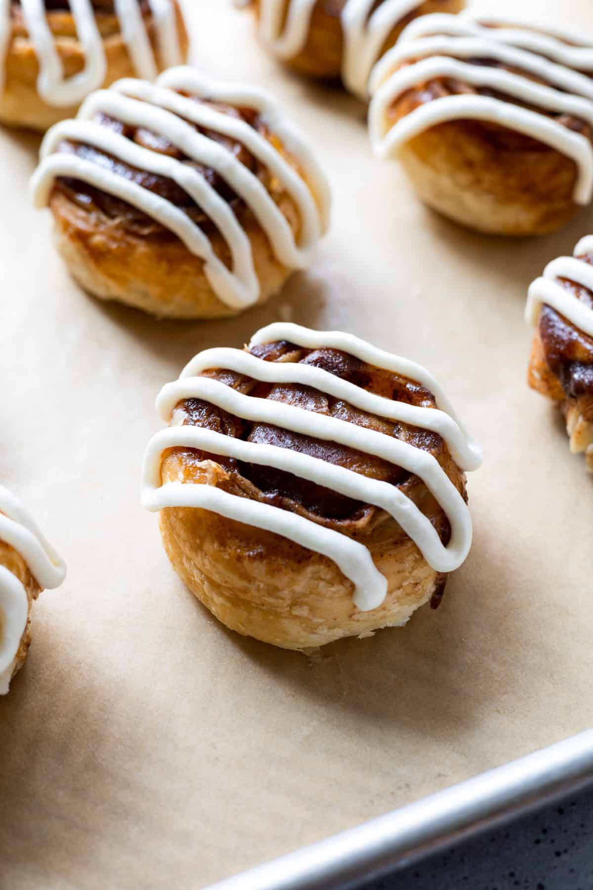A cream cheese iced puff pastry cinnamon roll.