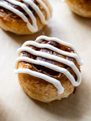 A cream cheese iced puff pastry cinnamon roll.