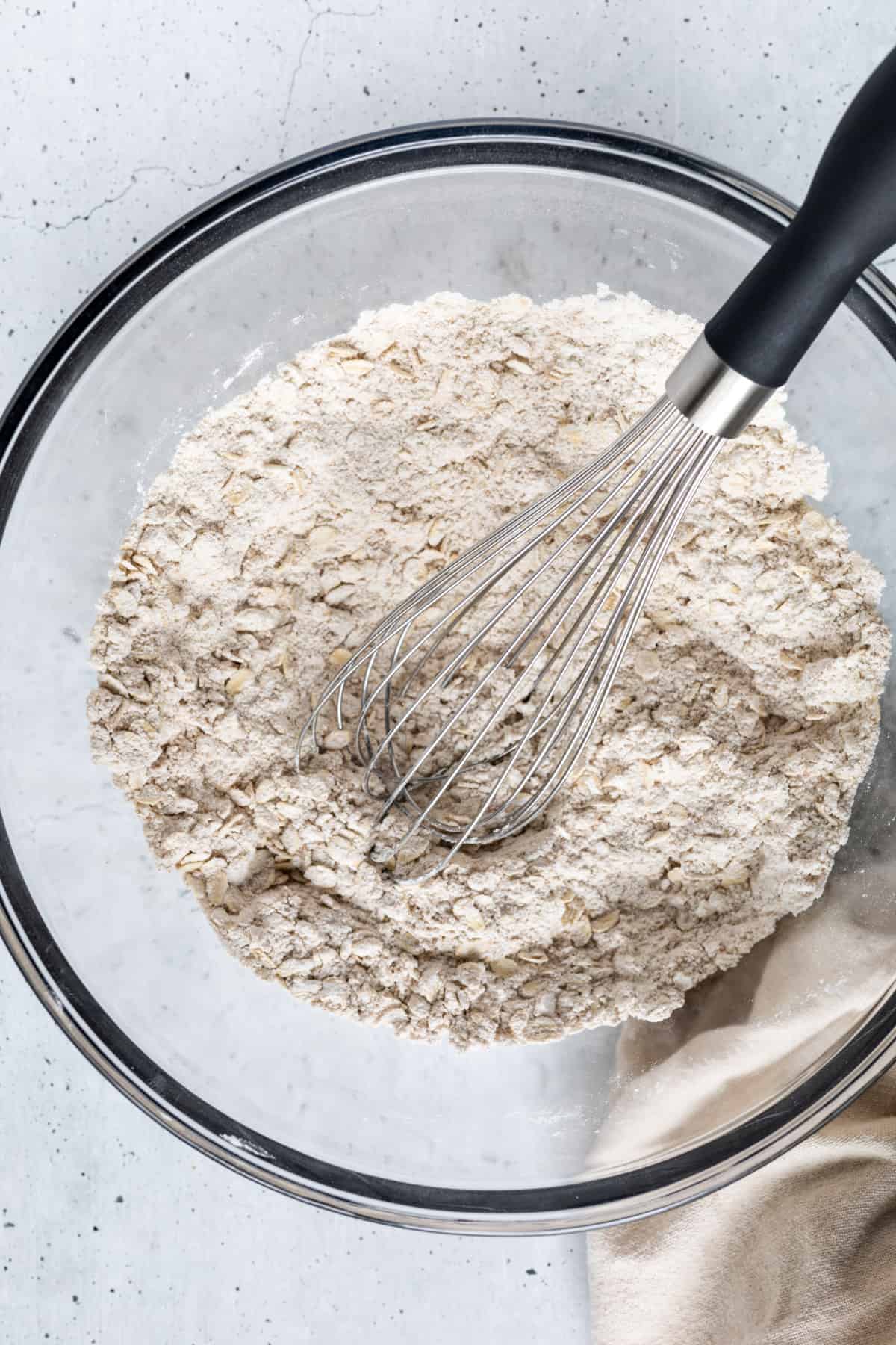 The dry ingredients in a large bowl with a whisk.