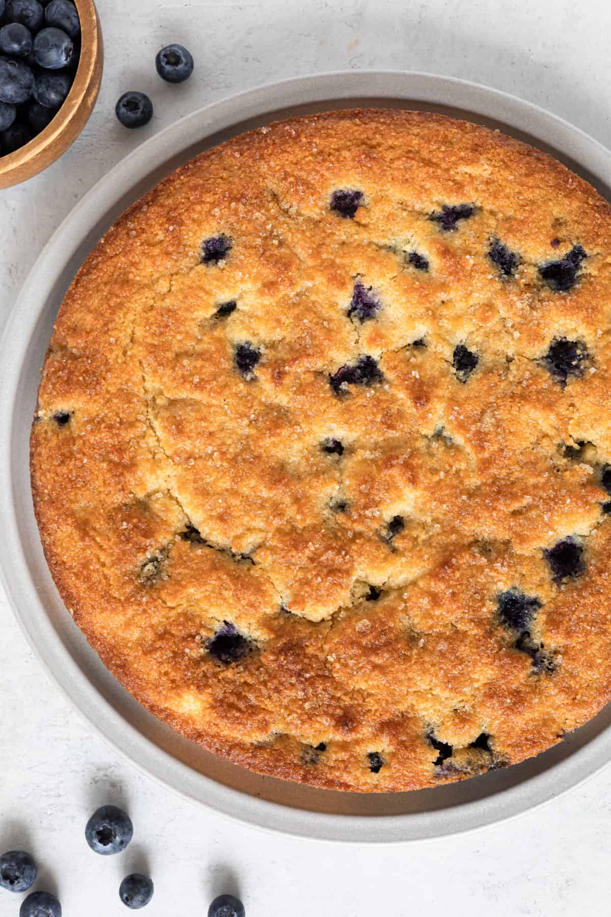 A whole low carb blueberry cake on a large plate.
