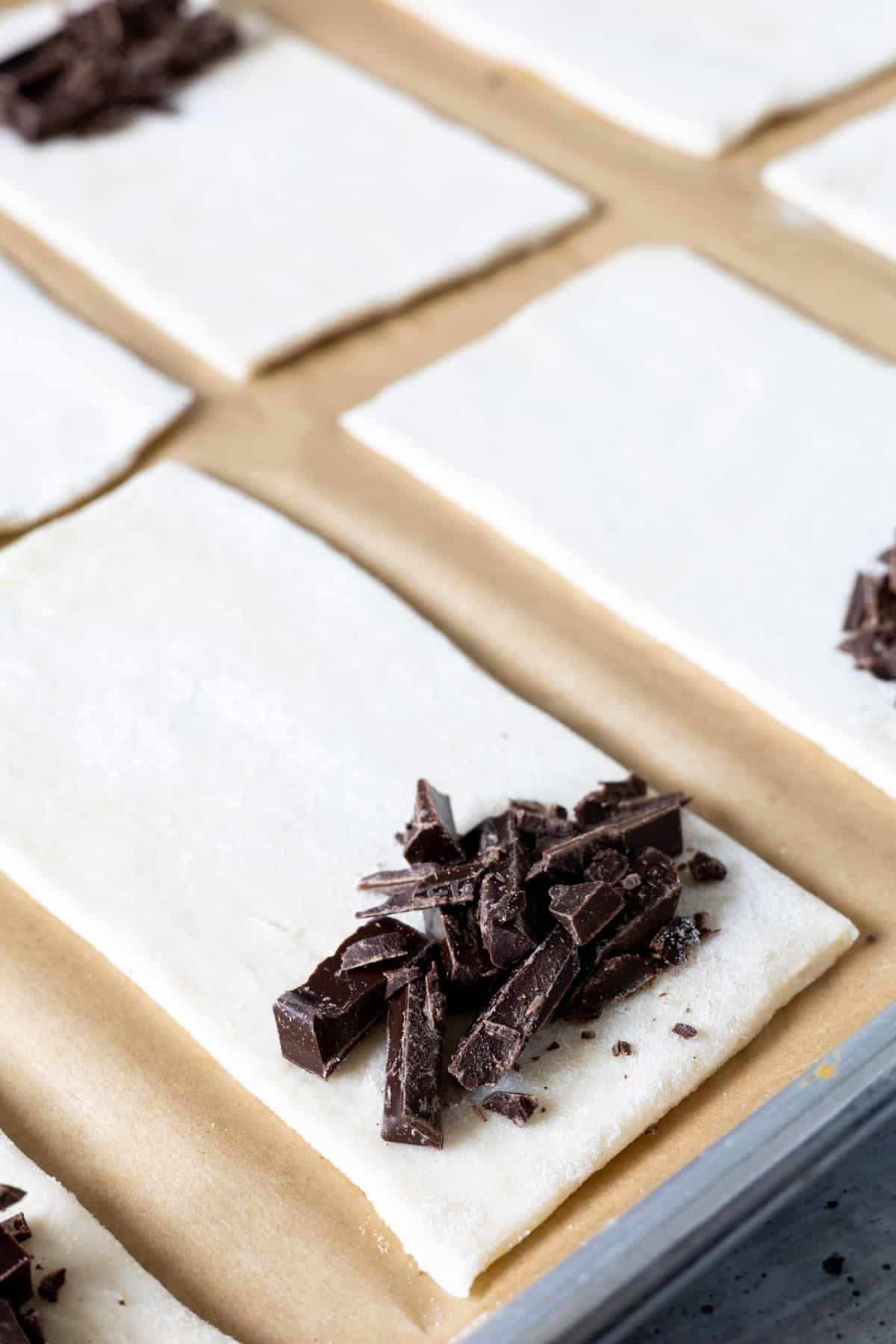 Chocolate pieces on a small rectangle of puff pastry.