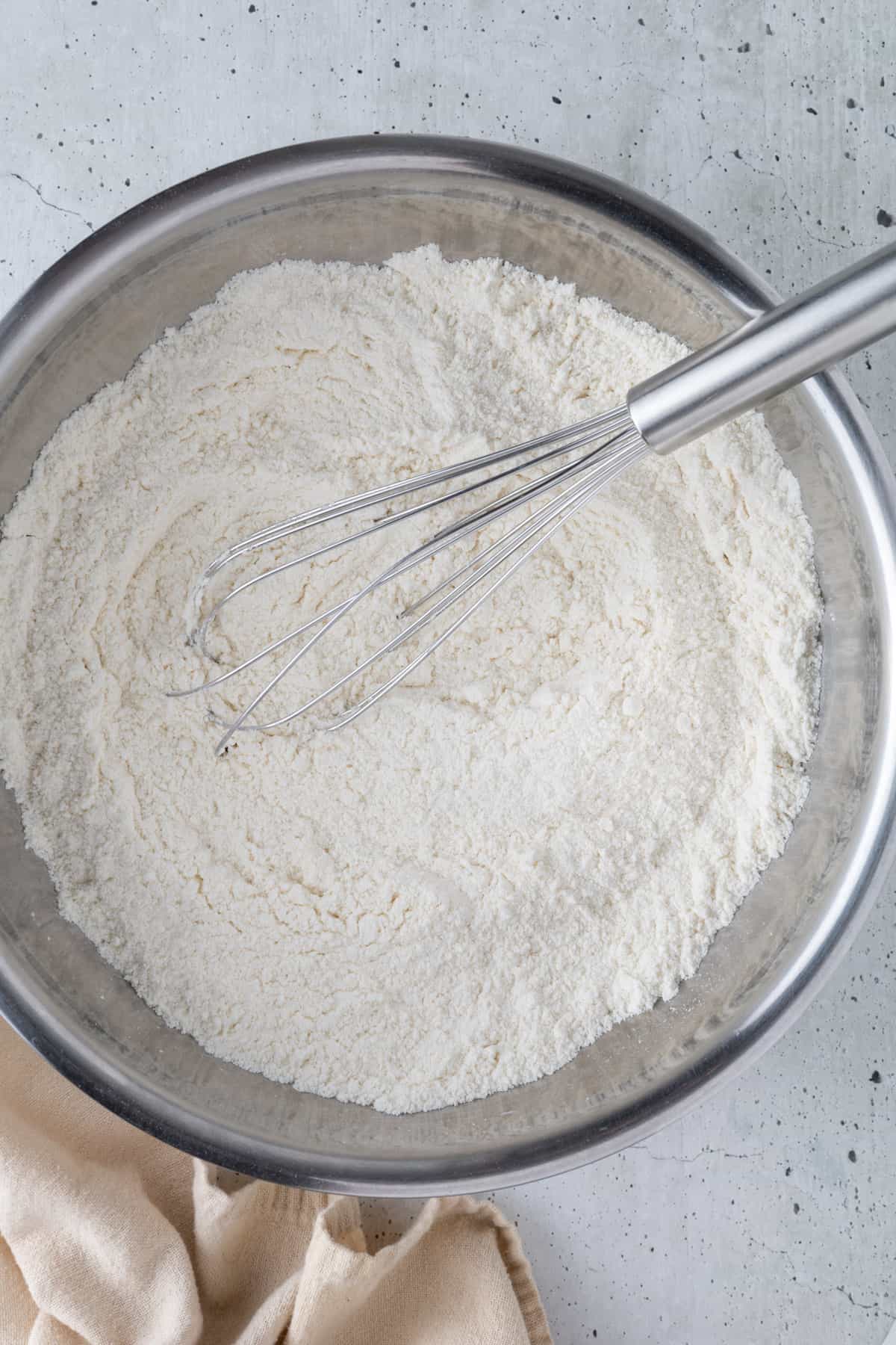 The dry ingredients in a medium bowl with a whisk.