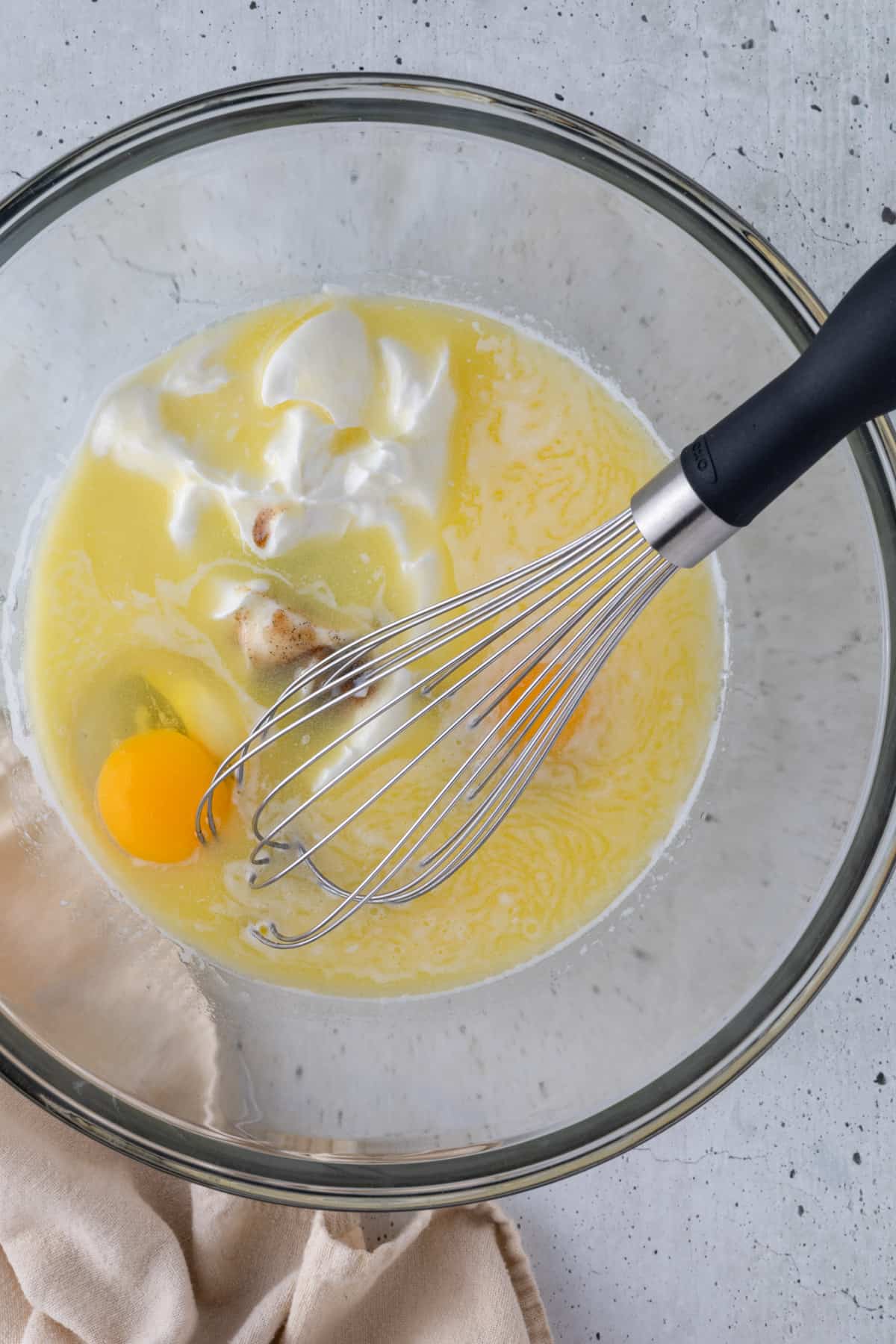The wet ingredients in a large bowl with a large whisk.