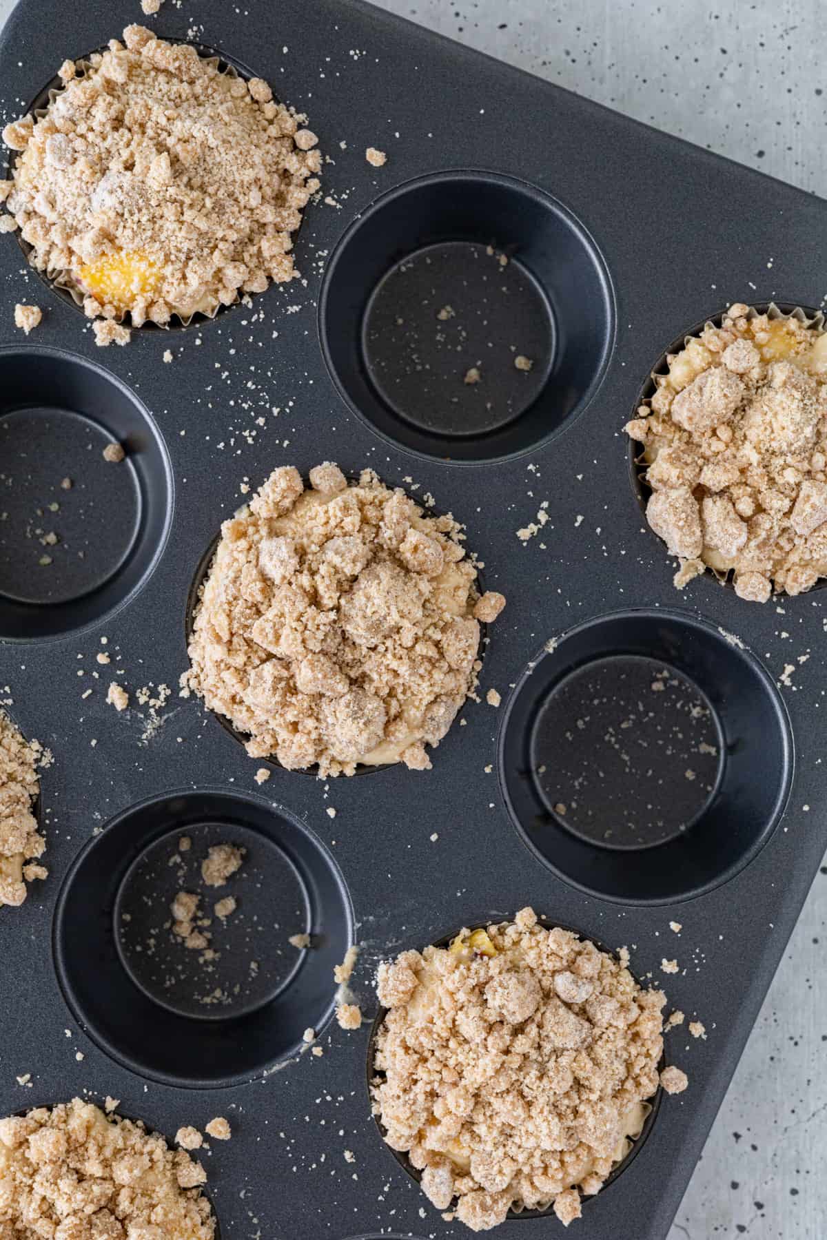 Unbaked muffins in a muffin pan.
