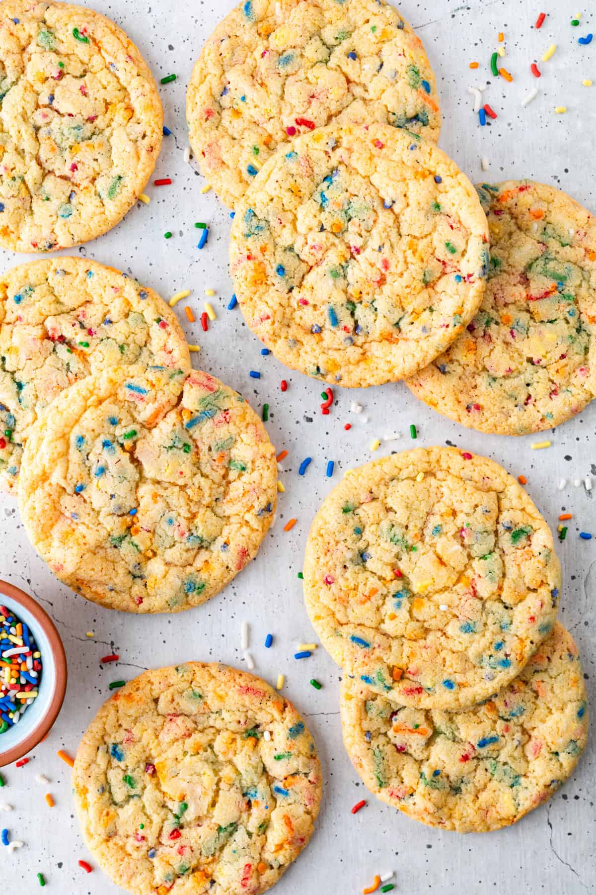An array of funfetti cookies with rainbow sprinkles.