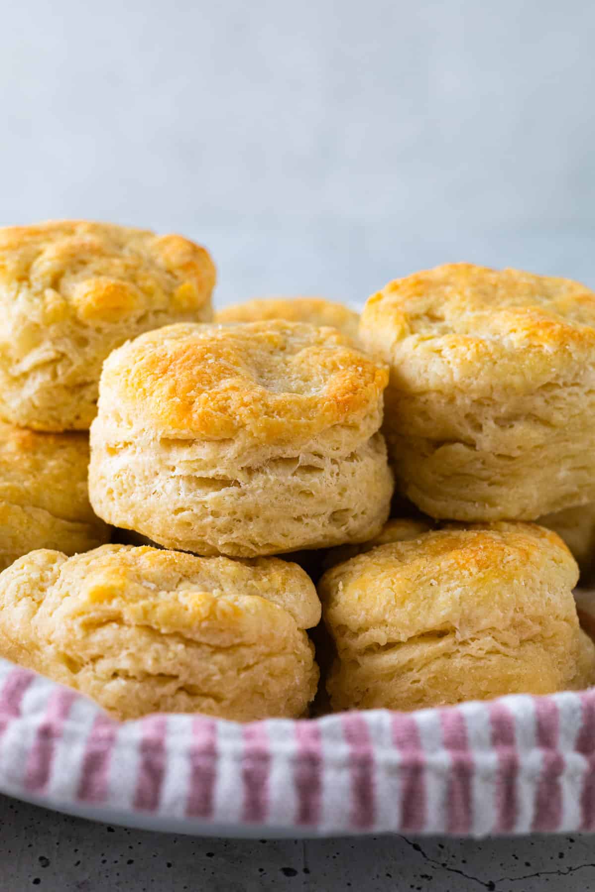 Biscuits stacked in a cloth-lined bowl.
