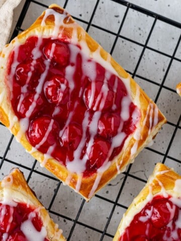 Cherry cream cheese danish on a wire cooling rack.