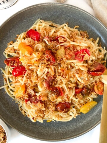 A plate of hearts of palm pasta garnished with fried onions.