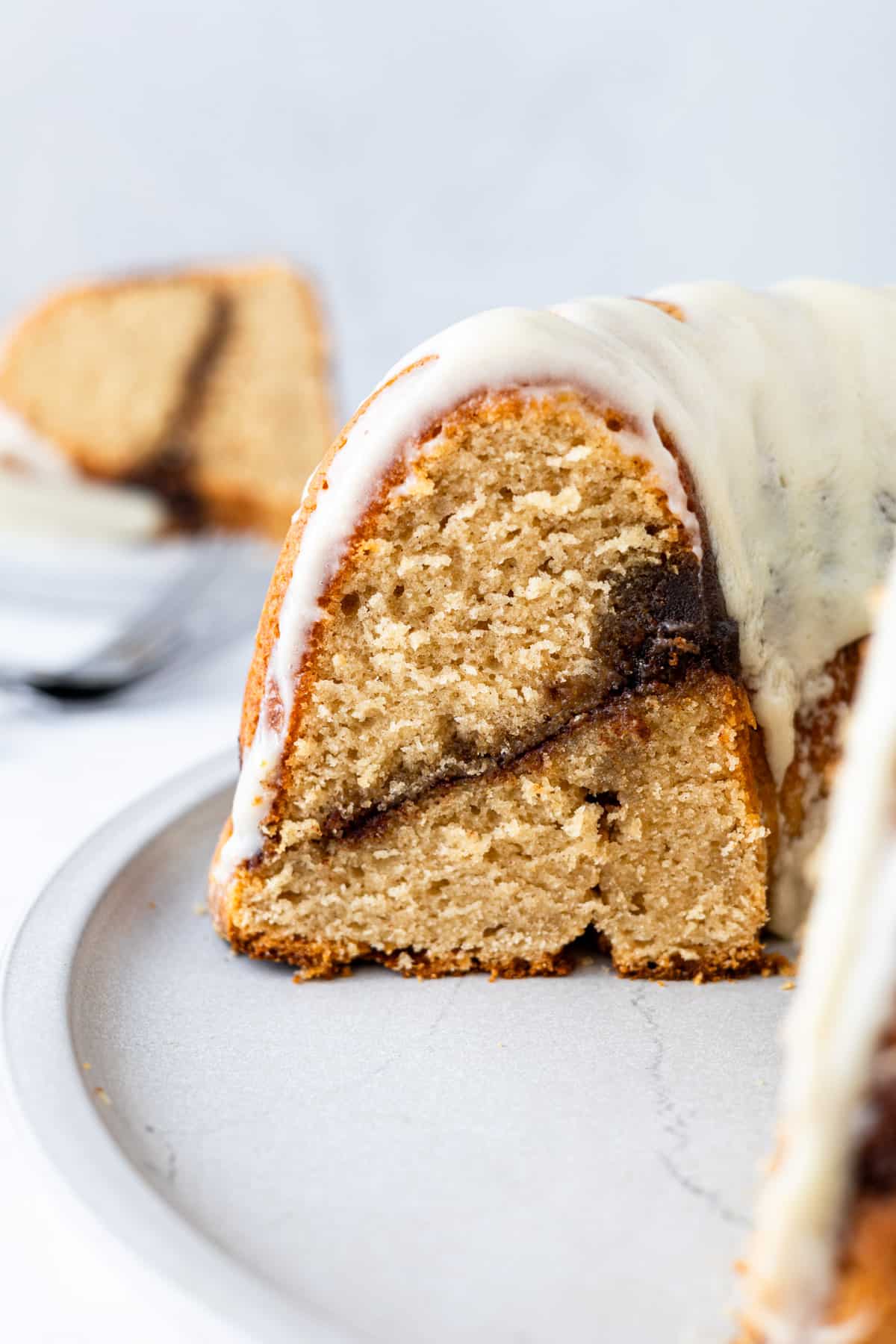 A cinnamon bundt cake that has been cut into.
